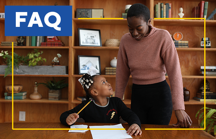  Adult and child working at a table